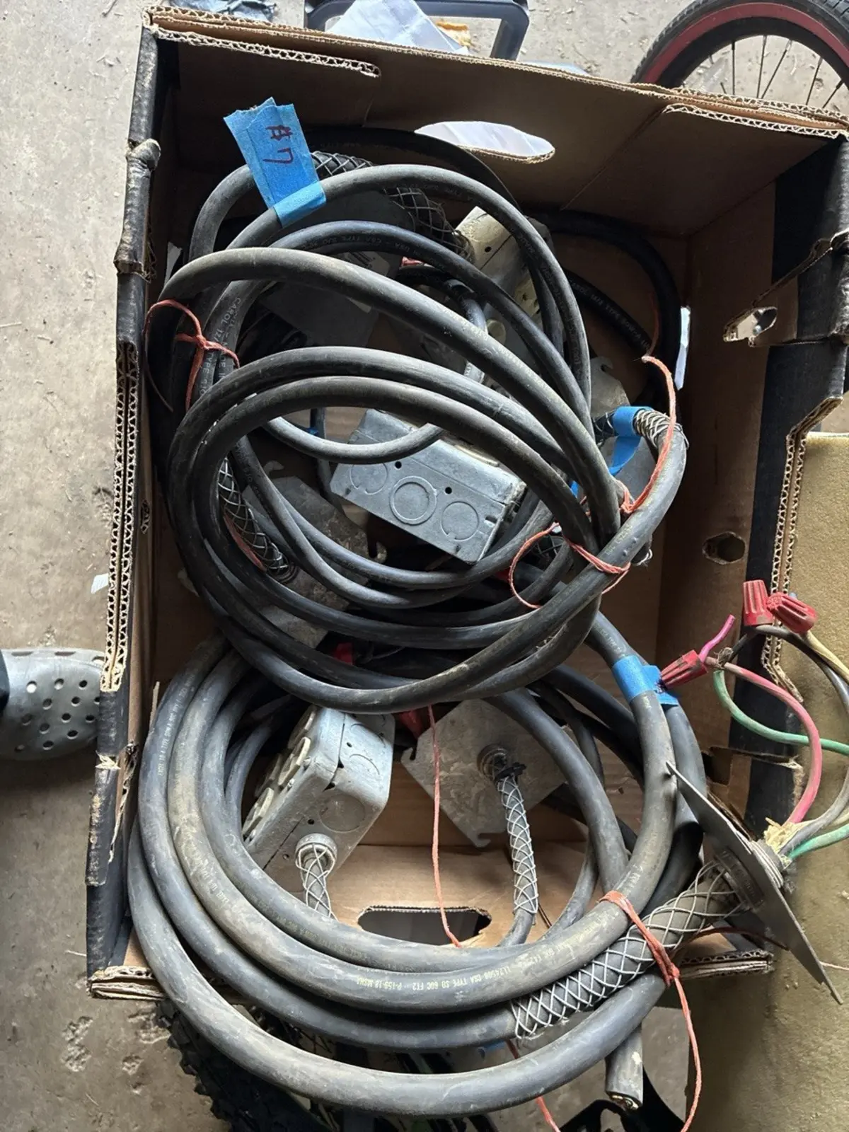 Box of SO cord from estate sale with junction boxes, flex conduit, and wire nuts