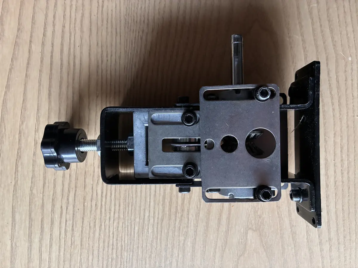 Drill-powered wire stripping machine overhead view showing blade mechanism and wire feed holes
